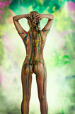 blond nude girl with multicolor over her body posing from back v