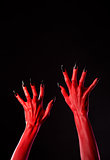 Red devil hands with black nails, real body-art 