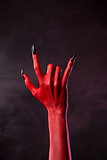 Red devil hand showing heavy metal gesture 