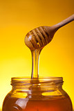 Close-up shot of wooden dipper with flowing honey 