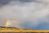 storm and rainbow over prairie