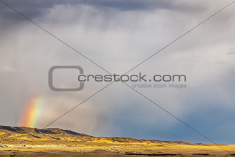 storm and rainbow over prairie