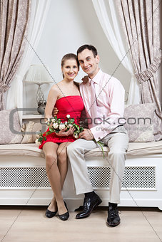 Happy young couple in luxury interior