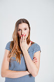 Attractive woman covering mouth with hand