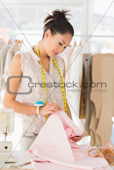 Concentrated female fashion designer at work
