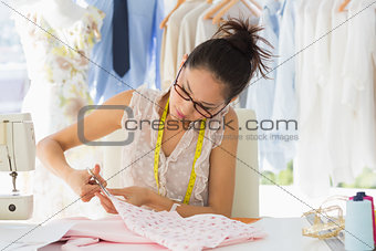 Concentrated fashion designer working on fabrics