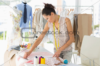Female fashion designer working on fabrics
