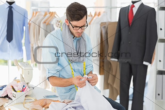 Concentrated male fashion designer at work