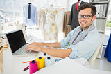 Male fashion designer using laptop