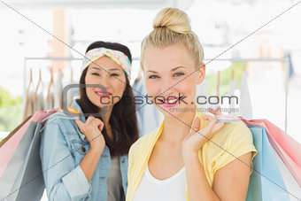 Happy young women with shopping bags