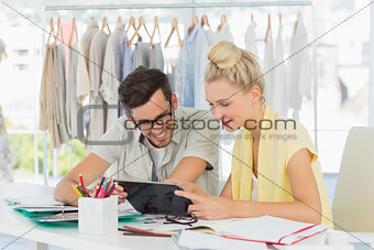 Fashion designers using digital laptop