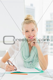 Portrait of a casual young woman with catalog