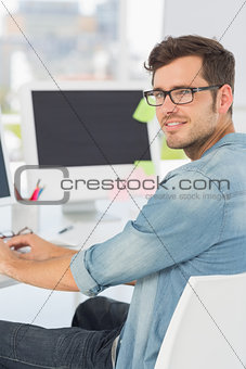 Side view portrait of a male artist using computer