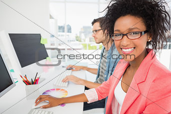 Casual young couple working on computers