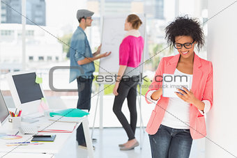 Artist using digital tablet with colleagues in at office