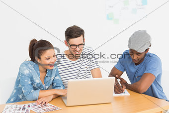 Artists working on laptop at the office