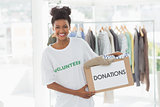 Smiling young woman with clothes donation