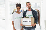 Smiling young couple with clothes donation