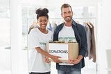 Smiling young couple with clothes donation