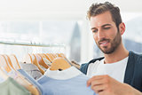 handsome male customer by clothes rack