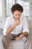 Relaxed man text messaging at home