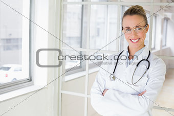 Beautiful female doctor with arms crossed in hospital