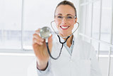 Smiling female doctor with stethoscope in hospital