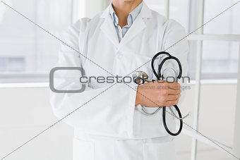 Mid section of a female doctor with stethoscope in hospital