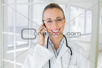 Beautiful female doctor using mobile phone