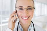 Closeup of a beautiful female doctor using mobile phone