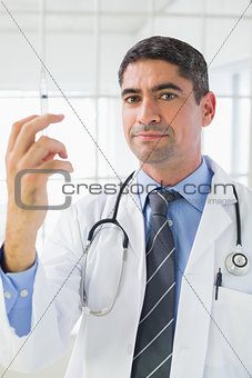 Portrait of male doctor holding an injection