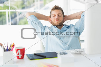Designer relaxing at his desk