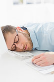 Exhausted designer sleeping at his desk