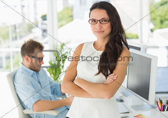 Pretty designer looking at camera leaning on desk