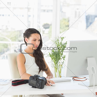 Beautiful photographer working at her desk