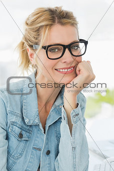 Blonde designer looking at the camera with a smile