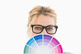 Blonde designer holding colour wheel