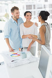Interior designer shaking hands with smiling client