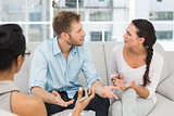 Unhappy couple arguing at therapy session