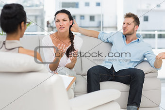 Angry couple talking to their therapist
