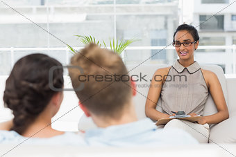 Therapist smiling at couple on the couch