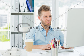Handsome man working at his desk