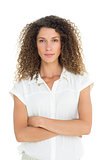 Serious woman looking at camera with arms crossed