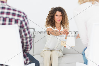 Therapist handing a tissue to woman at couples therapy
