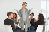 Rehab group applauding happy woman standing up
