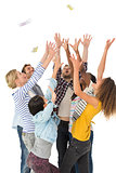 Happy group of young friends throwing money in the air