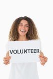 Smiling volunteer showing a poster
