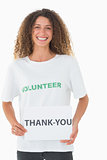 Smiling volunteer showing a thank you poster