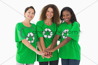 Team of environmental activists smiling at camera with hands together