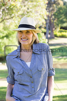 Happy woman wearing sunhat in park